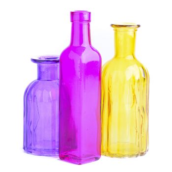 Three colorful bottles, isolated on white background