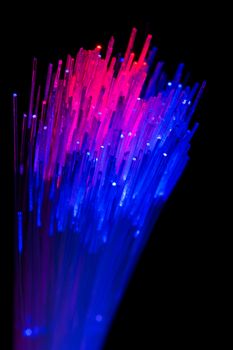 bunch of optical fibres flying from deep as blurred abstract technology background