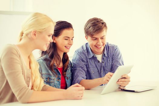 technology, internet, school and education concept - group of smiling teenage students with tablet pc computers at school