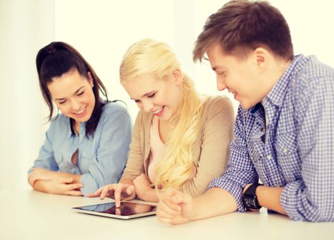 technology, internet, school and education concept - group of smiling teenage students with tablet pc computer at school