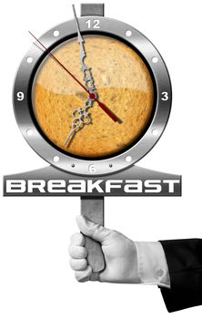 Hand of chef holding a metal sign with clock, rusk and text Breakfast. Isolated on white background