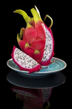 Luxurious dragon fruit isolated on black background. Tropical fruit, luxurious minimal style. 