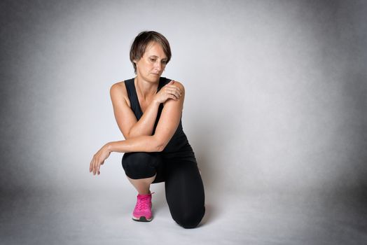 Image of middle aged thoughtful woman in sportswear