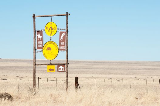 KOIIMASIS, NAMIBIA - JUNE 24, 2012: Sign post in the barren semi-desert area bordering the D707 road between Sesriem and Aus