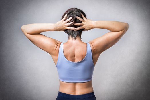 Middle aged handsome woman doing a stretching exercise