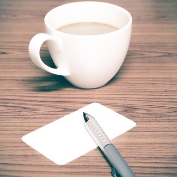 coffee cup and business card on wood background vintage style