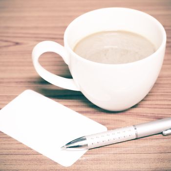 coffee cup and business card on wood background vintage style