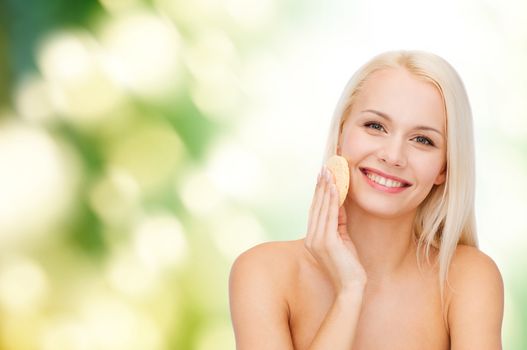 health, beauty and spa concept - beautiful woman with sponge