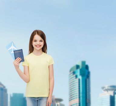 travel, holiday, vacation, childhood and transportation concept - smiling little girl with airplane ticket and passport