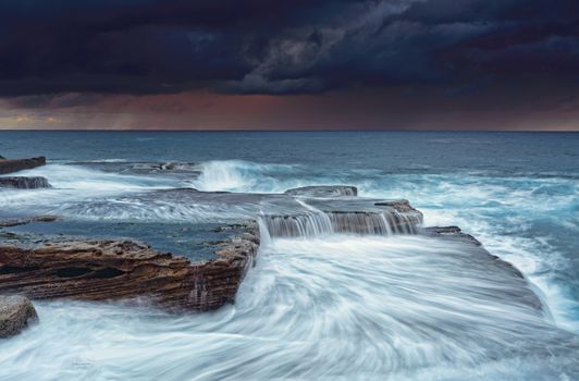 Stormy sunrise skies and turbulent seas at Maroubra
