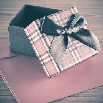 red gift box and envelope on wood background