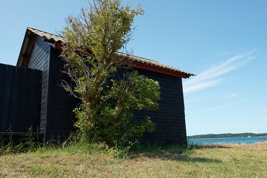 Small wooden vacation summer house in an attractive location by the sea