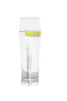 Mineral water glass isolated with lemon slice.