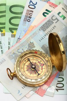 Compass and euro bills close up. business background