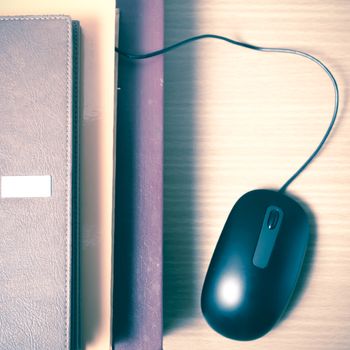 book and computer mouse on wood background vintage style