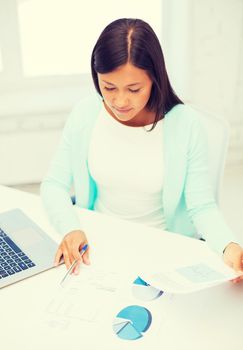 business, education and technology concept - asian businesswoman or student with laptop and documents in office