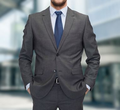 business and people concept - close up of businessman standing over business center background