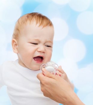 child and toddle concept - crying baby with dummy