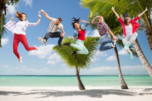 summer, sport, dancing, vacation and teenage lifestyle concept - group of teenagers jumping