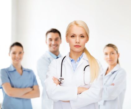 healthcare and medicine concept - serious female doctor with stethoscope