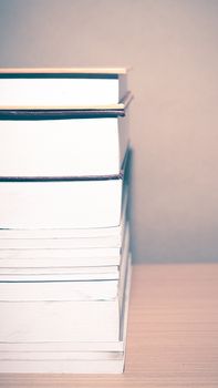 stack of book on wood table background vintage style