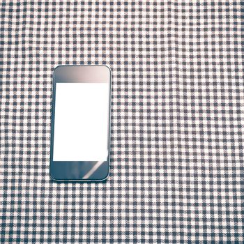 smart phone on kitchen towel background vintage style