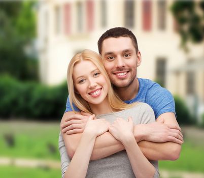 love and family concept - smiling couple hugging