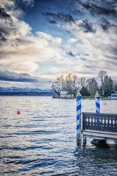 Evening mood of lake at Tutzing Bavaria Germany with landing bridge