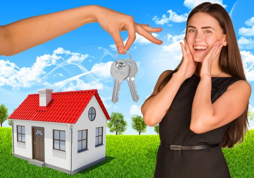 Happy young lady with house and hand holding keys