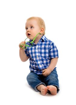 blue-eyed baby boy in a plaid shirt with glasses. Studio. Isolated