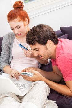 Sweet Young Couple Relaxing on the Couch in the Living Room, Watching a Movie on Laptop Computer Together.