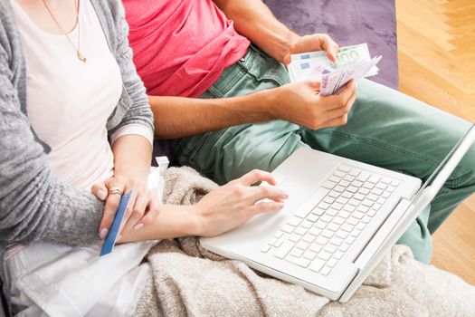 Sweet Young Couple Relaxing on the Couch in the Living Room, Watching a Movie on Laptop Computer Together.