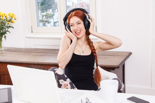 Happy Young Pretty Woman Laughing While Listening Funny Music Using Headphone Inside her Room.