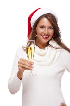 Playful woman wearing a festive red Santa hat and holding a flute of champagne celebrating Christmas blowing a kiss across the palm of her hand with a mischievous smile, on white