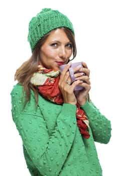 Close up Pretty Young Woman Wearing Green and Red Winter Fashion, Holding a Cup of Coffee While Smiling at the Camera. Isolated on White Background.