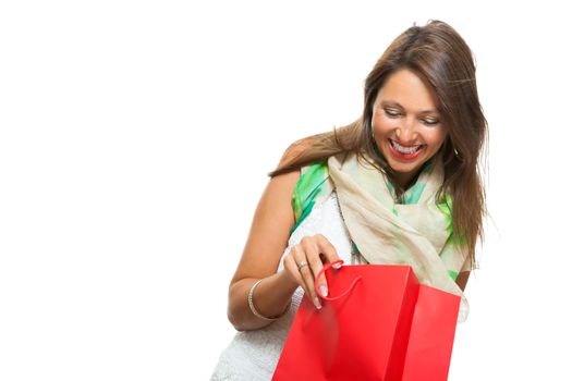 Close up Smiling Fashionable Woman Looking Inside a Red Shopping Paper Bag. Isolated on White Background.