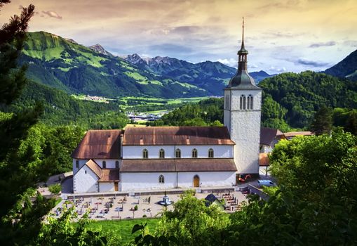 Saint-Theodule church and Alps mountains in the background, Gruyeres, Switzerland