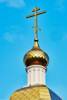  Cross on the dome of the Orthodox Church against the blue sky                             