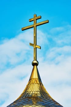  Cross on the dome of the Orthodox Church against the blue sky                             