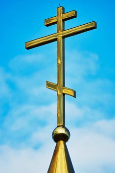  Cross on the dome of the Orthodox Church against the blue sky                             