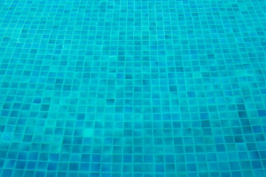 Blue mosaic tiles on the ground of swimming pool
