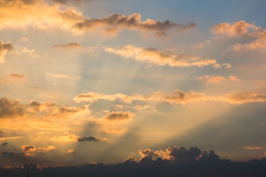 Sun ray beam behind cloud over sky