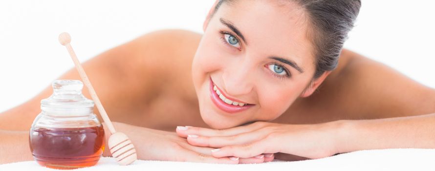 Portrait smiling pretty brunette on massage table with white backgroung