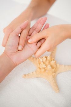 A woman having a hand massage at spa center 