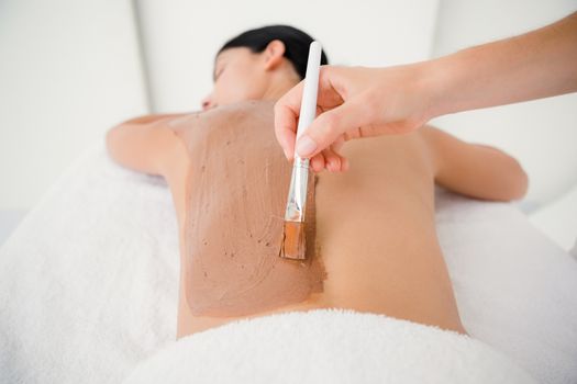 Beautiful brunette enjoying a chocolate beauty treatment at the health spa