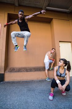 Group of people doing parkour in the city on a sunny day