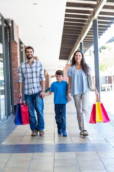 Happy family with shopping bags at the mall