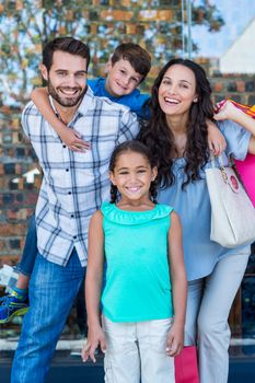 Portrait of a happy family having fun in the mall on a sunny day