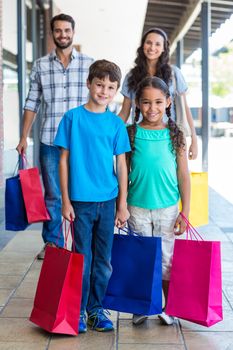 Happy family having fun in the mall on a sunny day