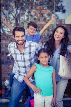 Portrait of a happy family having fun in the mall on a sunny day